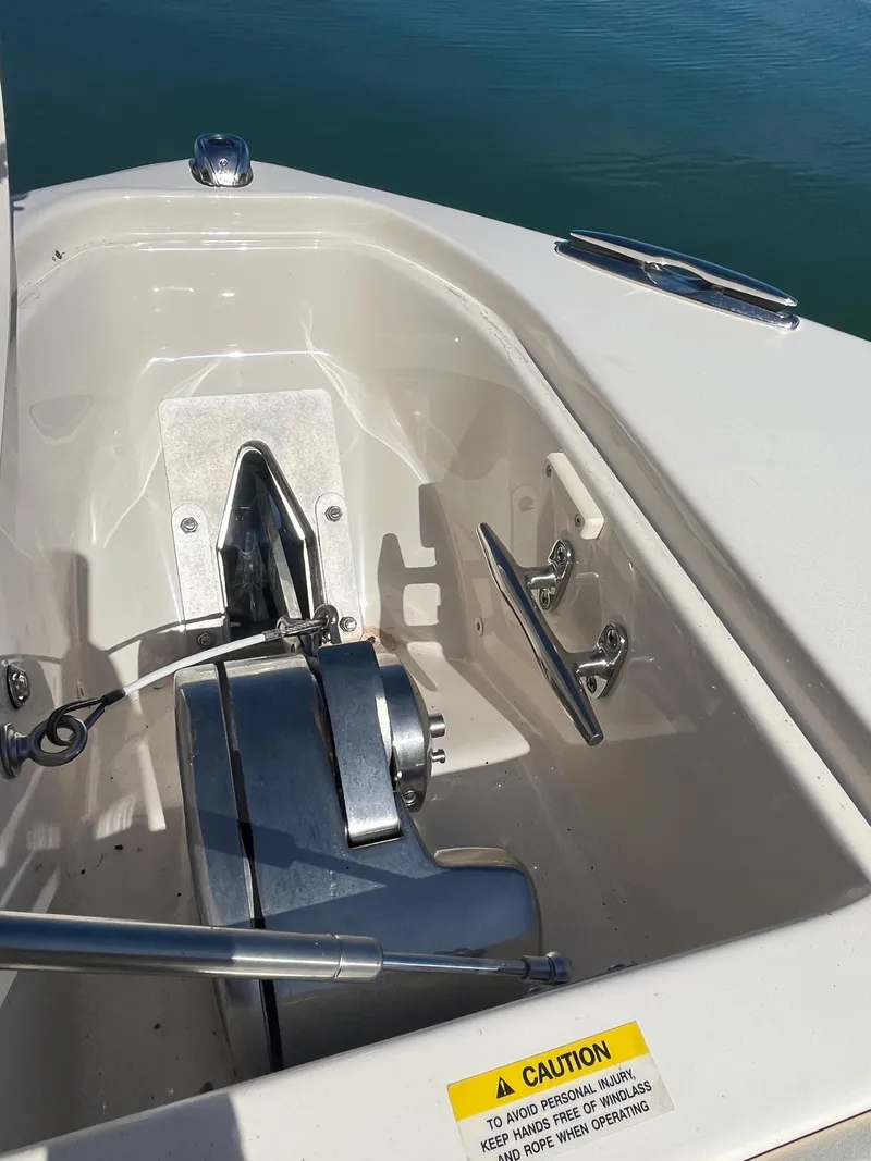 Slide: The Image of Anchor compartment of 2023 Grady-White Freedom 275 boat, featuring winch and cleat. - 39