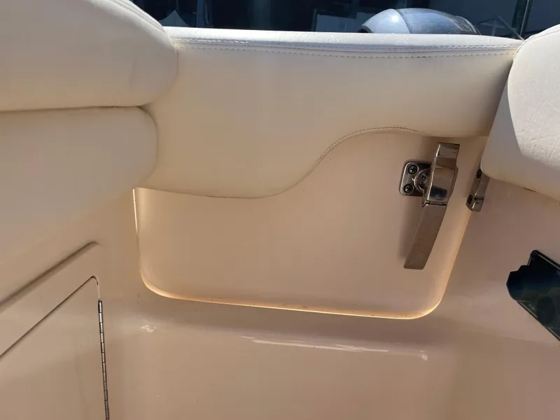 Slide: The Image of Interior detail of 2023 Grady-White Freedom 275 boat, featuring a sleek latch and cushioned seating. - 40