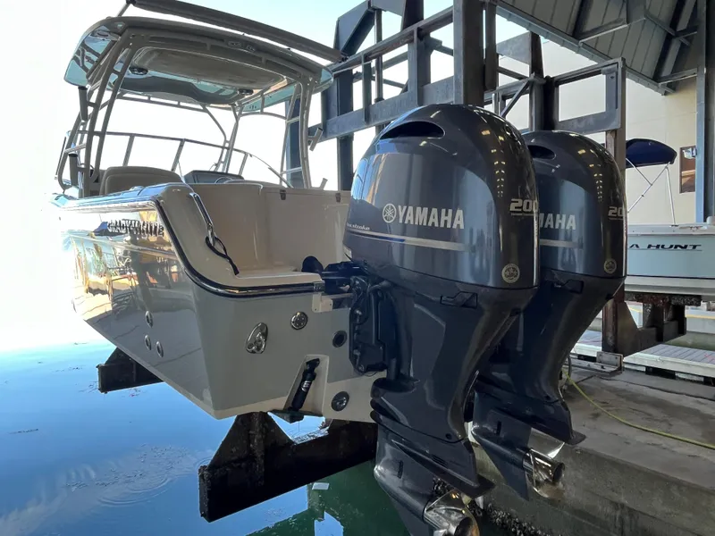 Slide: The Image of 2023 Grady-White Freedom 275 boat with dual Yamaha 200 engines in a marina setting. - 41