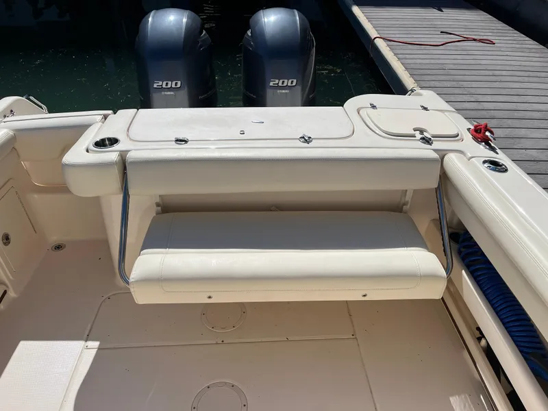 Slide: The Image of 2023 Grady-White Freedom 275 boat interior with twin Yamaha 200 engines at dock. - 42
