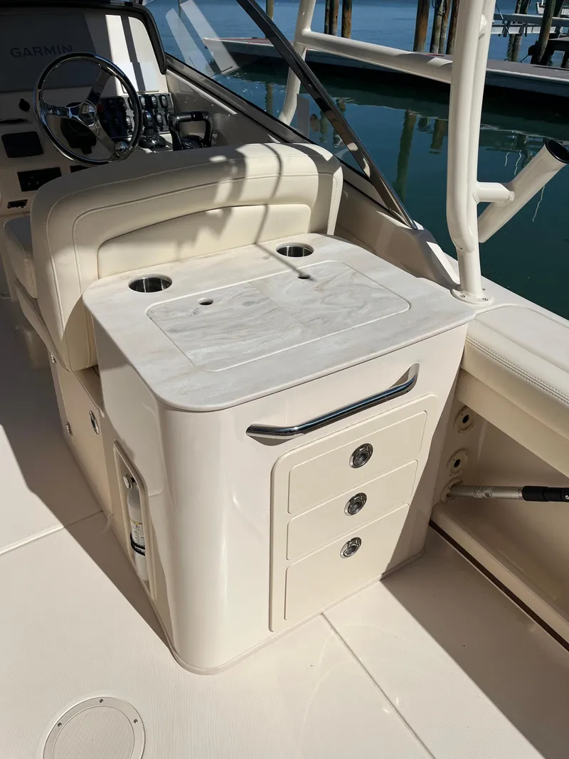 Slide: The Image of 2023 Grady-White Freedom 275 boat interior with storage and seating. - 43