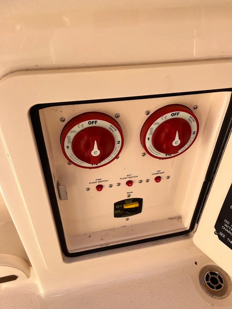 Slide: The Image of Control panel of 2023 Grady-White Freedom 275 boat with red switches and indicators. - 47