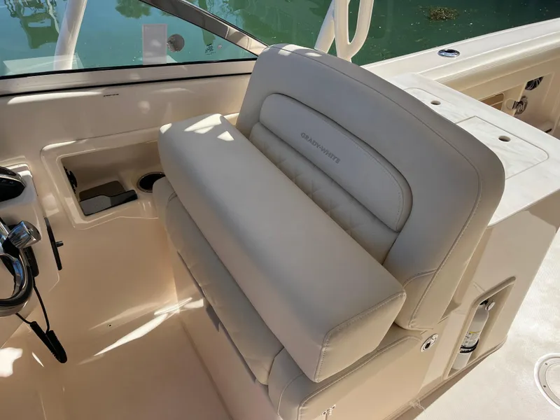 Slide: The Image of 2023 Grady-White Freedom 275 boat interior with beige seating and control panel. - 48