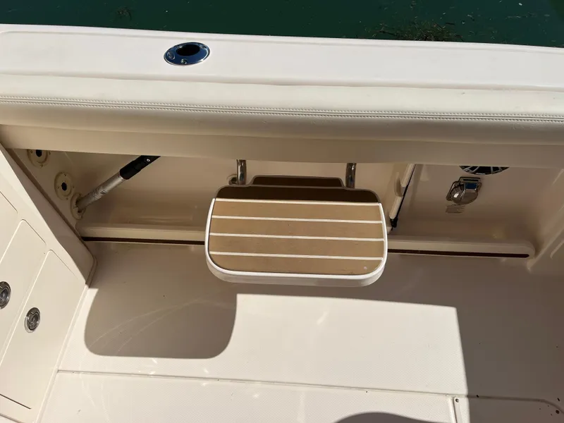 Slide: The Image of 2023 Grady-White Freedom 275 boat interior with foldable step and rod holder. - 5