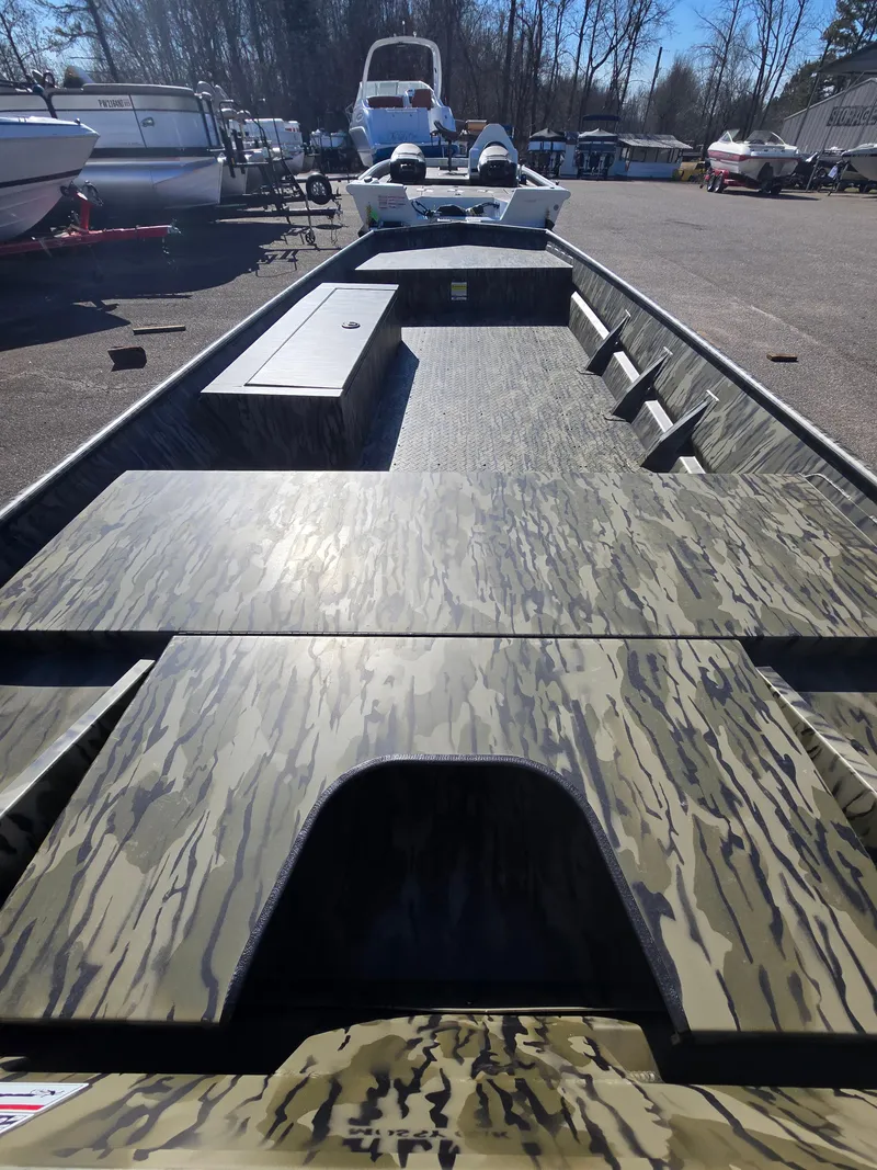 Slide: The Image of 2025 SeaArk MV 1652 Jet boat with camouflage design, parked outdoors. - 2