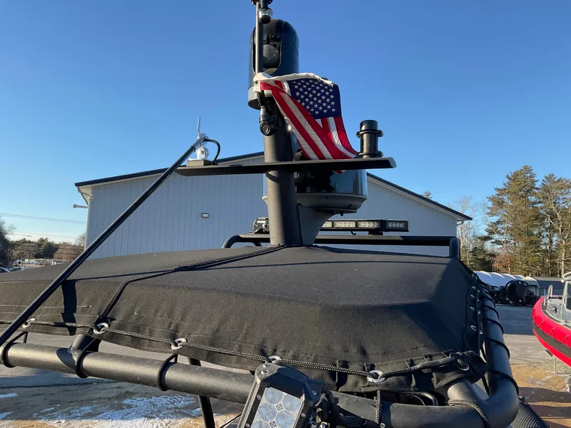 Slide: The Image of Ocean Craft Marine 9.5 M boat, 2017 model, with American flag, docked outdoors. - 12