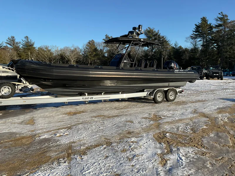 Slide: The Image of 2017 Ocean Craft Marine 9.5 M boat on trailer, parked on snowy ground. - 27