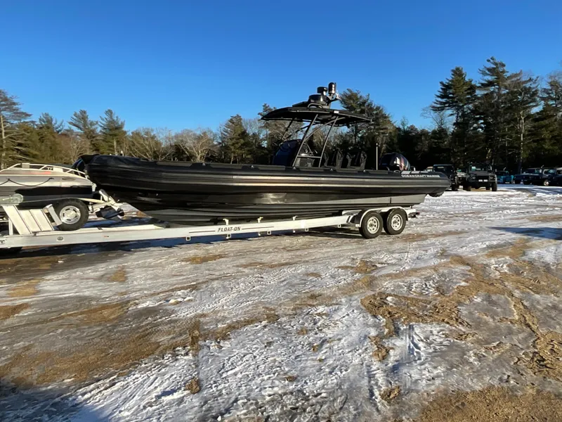 Slide: The Image of Ocean Craft Marine 9.5 M boat on trailer, 2017 model, parked on snowy ground. - 28