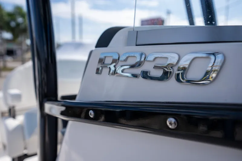 Slide: The Image of 2025 Robalo R230 Center Console boat, close-up of model emblem. - 10