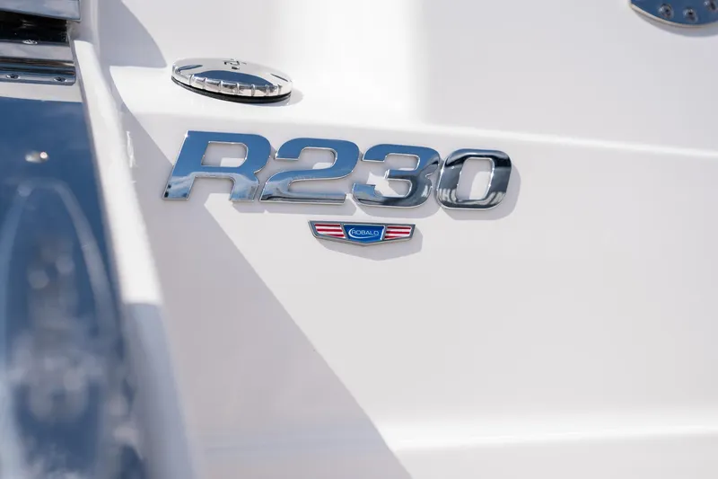 Slide: The Image of 2025 Robalo R230 Center Console boat emblem on white surface. - 15
