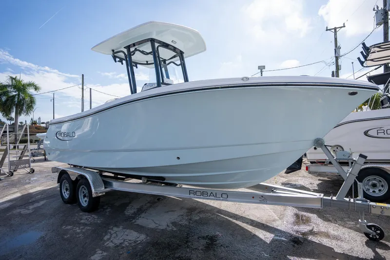 Slide: The Image of 2025 Robalo R230 Center Console boat on trailer, displayed outdoors under clear sky. - 3