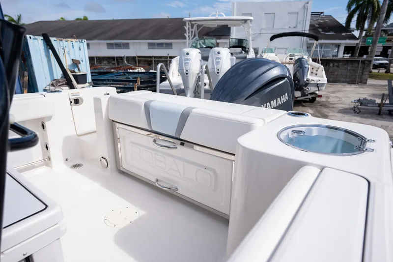 Slide: The Image of 2025 Robalo R230 Center Console boat interior with Yamaha engine in a marina setting. - 5