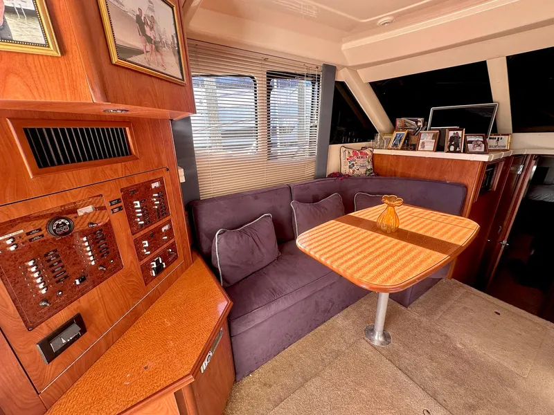 Slide: The Image of Interior of 2007 Silverton 330 Sport Bridge with cozy seating and dining area. - 12