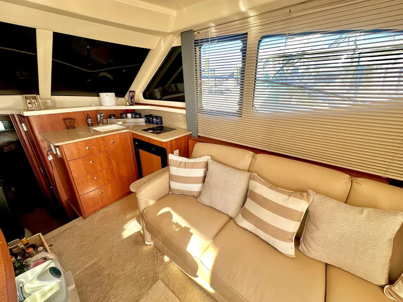 Slide: The Image of Interior of 2007 Silverton 330 Sport Bridge yacht with cozy seating and kitchenette. - 13