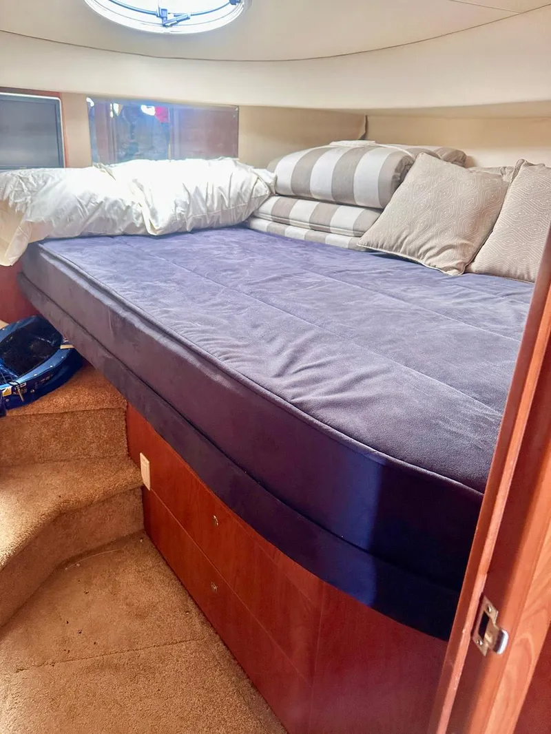 Slide: The Image of 2007 Silverton 330 Sport Bridge cabin interior with bed and cushions. - 16