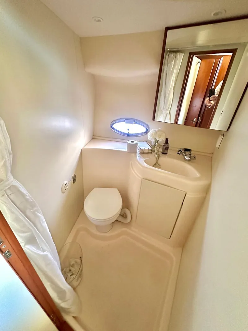 Slide: The Image of 2007 Silverton 330 Sport Bridge bathroom with toilet, sink, and mirror. - 17