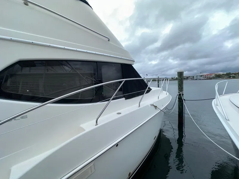 Slide: The Image of 2007 Silverton 330 Sport Bridge yacht docked on a cloudy day. - 4