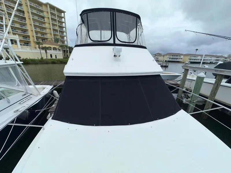 Slide: The Image of 2007 Silverton 330 Sport Bridge docked near waterfront buildings. - 5