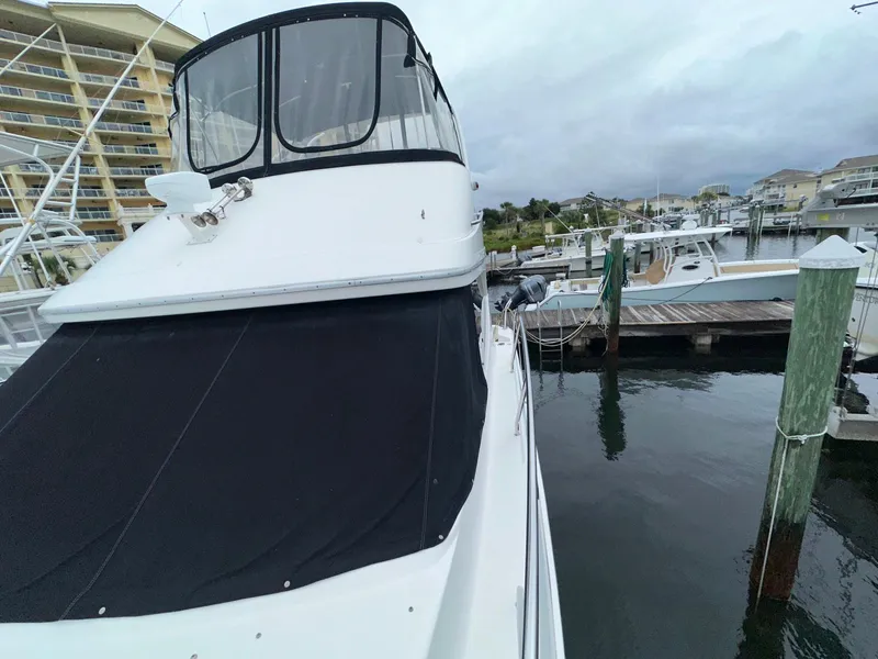 Slide: The Image of 2007 Silverton 330 Sport Bridge docked at marina, featuring sleek design and covered deck. - 6