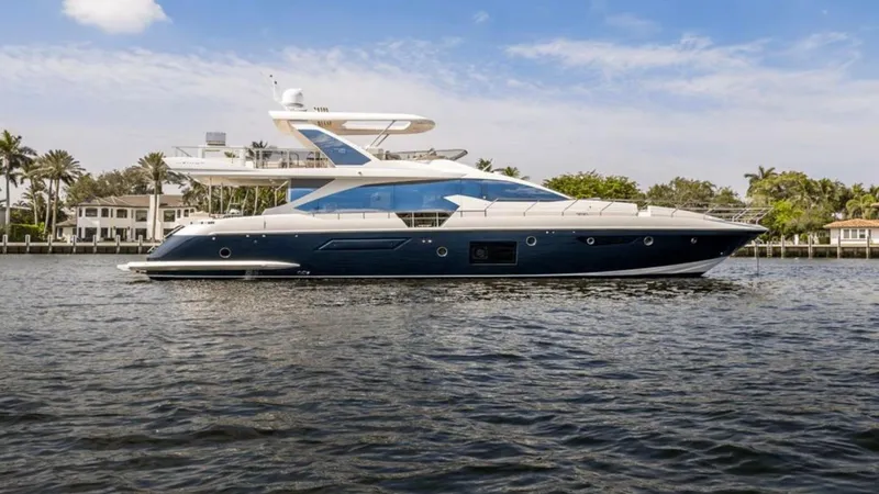 The Image of 2016 Azimut Fly 72 yacht on calm water, with luxury homes in the background. - 1