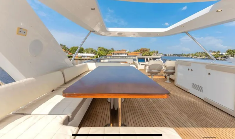 Slide: The Image of Azimut Fly 72 yacht deck, 2016 model, featuring spacious seating and a wooden table. - 11