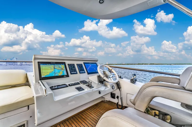 Slide: The Image of Luxurious 2016 Azimut Fly 72 yacht cockpit with navigation screens, steering wheel, and ocean view. - 12
