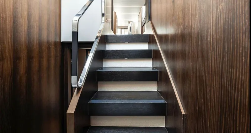 Slide: The Image of Staircase inside 2016 Azimut Fly 72 yacht with sleek wooden paneling. - 25