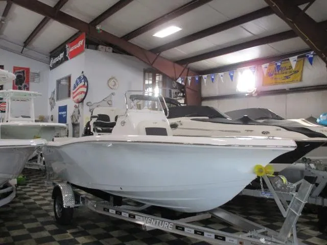 The Image of 2025 Tidewater 198 CC Adventure boat displayed in a showroom on a trailer. - 1