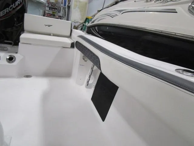 Slide: The Image of 2025 Tidewater 198 CC Adventure boat interior with seating and storage features. - 10