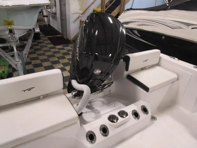 Slide: The Image of 2025 Tidewater 198 CC Adventure boat interior with engine and seating. - 12