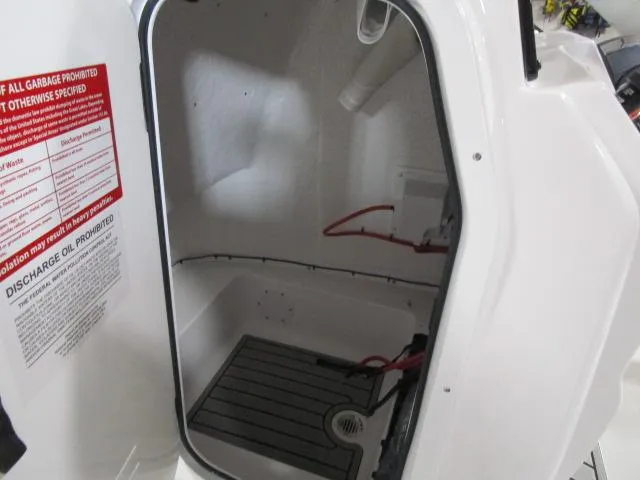 Slide: The Image of 2025 Tidewater 198 CC Adventure boat storage compartment with safety instructions. - 14