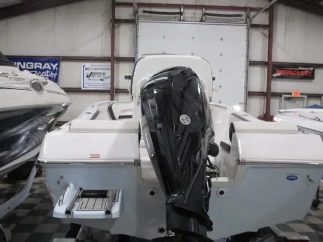 Slide: The Image of 2025 Tidewater 198 CC Adventure boat in showroom, rear view with outboard motor. - 3