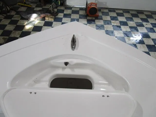 Slide: The Image of 2025 Tidewater 198 CC Adventure boat bow with storage compartment, indoors on checkered floor. - 8