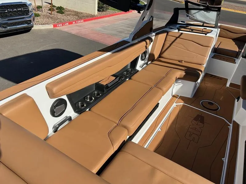 Slide: The Image of 2025 Axis T235 boat interior with tan leather seating and modern design. - 10