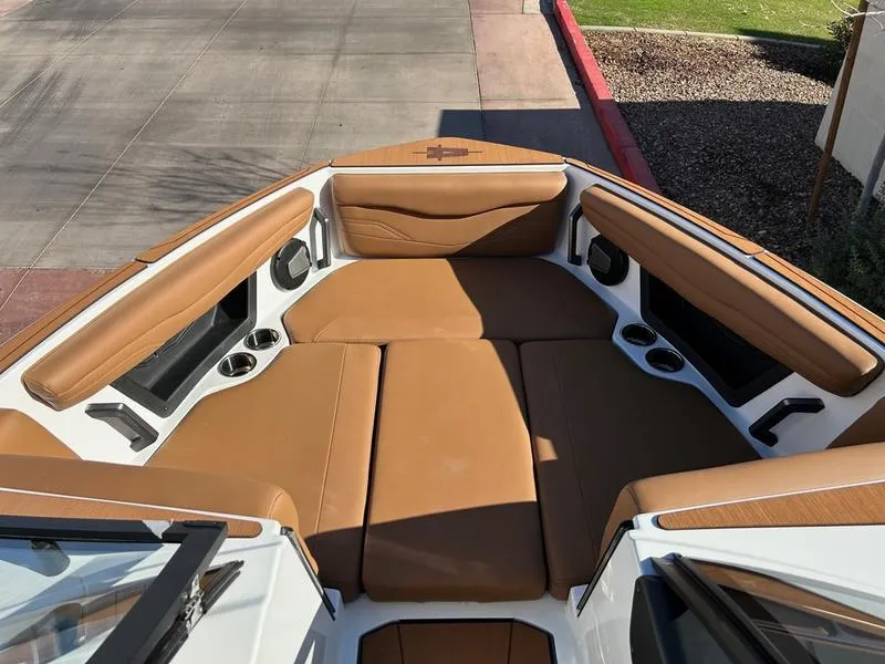 Slide: The Image of 2025 Axis T235 boat interior with tan leather seating and cup holders. - 12