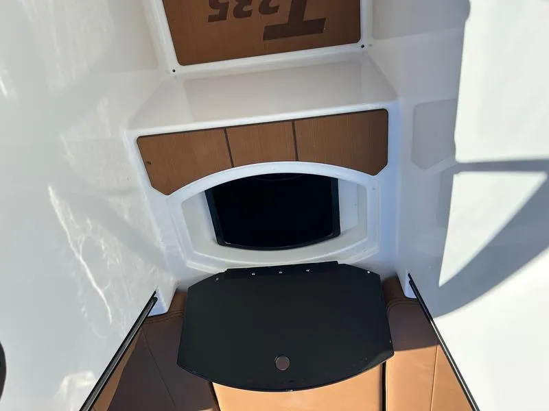 Slide: The Image of 2025 Axis T235 boat interior with storage compartment and sleek design. - 14