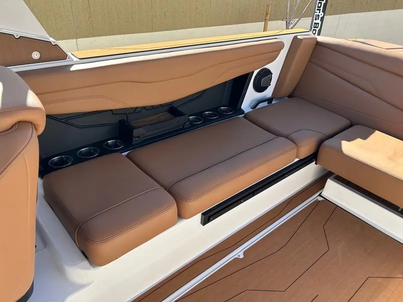 Slide: The Image of Luxurious seating in 2025 Axis T235 boat with brown upholstery and integrated cup holders. - 16