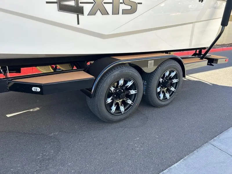 Slide: The Image of 2025 Axis T235 trailer with dual black alloy wheels on pavement. - 6