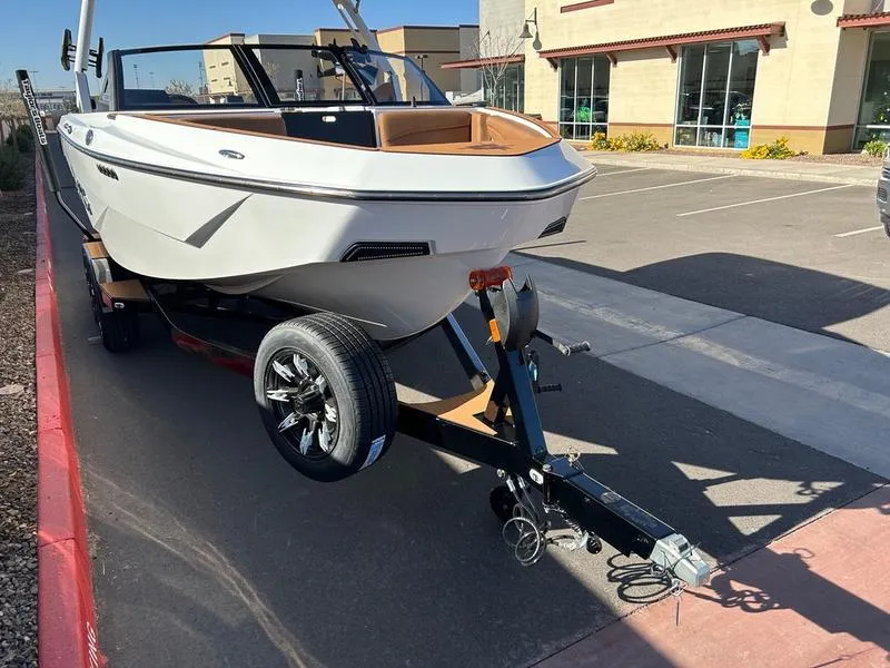 Slide: The Image of 2025 Axis T235 boat on trailer in parking lot, sunny day. - 7