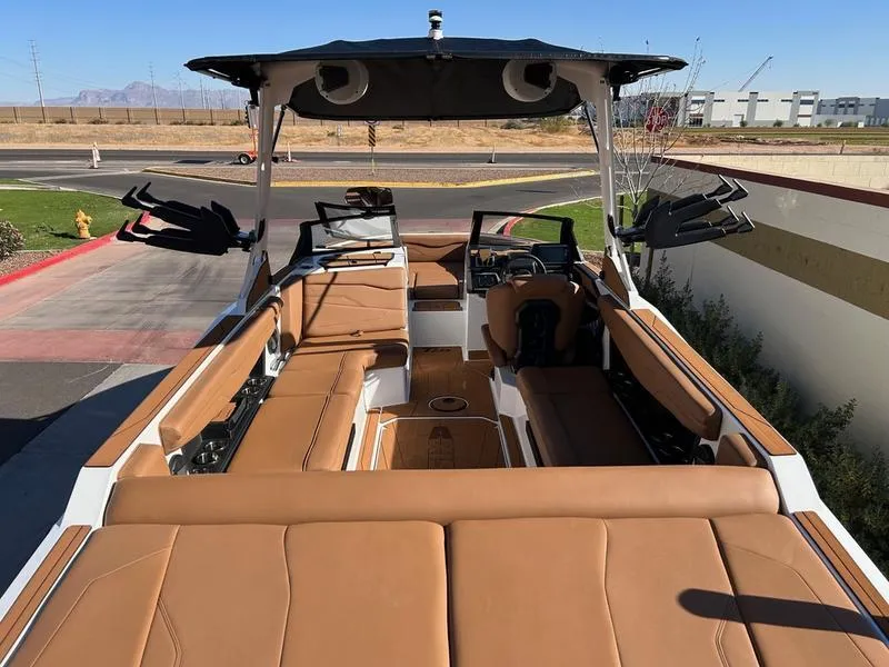 Slide: The Image of 2025 Axis T235 boat with tan leather interior, spacious seating, and modern design. - 9