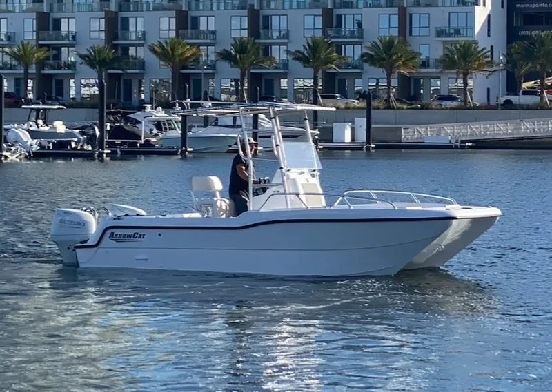 Slide: The Image of 2025 ArrowCat 20 CC boat cruising in marina with modern buildings in background. - 3