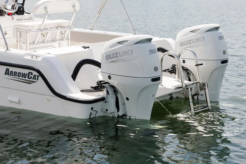 Slide: The Image of 2025 ArrowCat 20 CC boat with dual Suzuki outboard motors on water. - 7