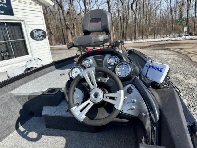 Slide: The Image of 2024 Bass Tracker Pro Team 175 boat dashboard with steering wheel and gauges. - 5