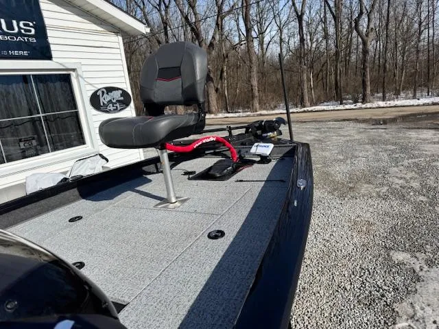 Slide: The Image of 2024 Bass Tracker Pro Team 175 boat with seating, parked outdoors. - 6