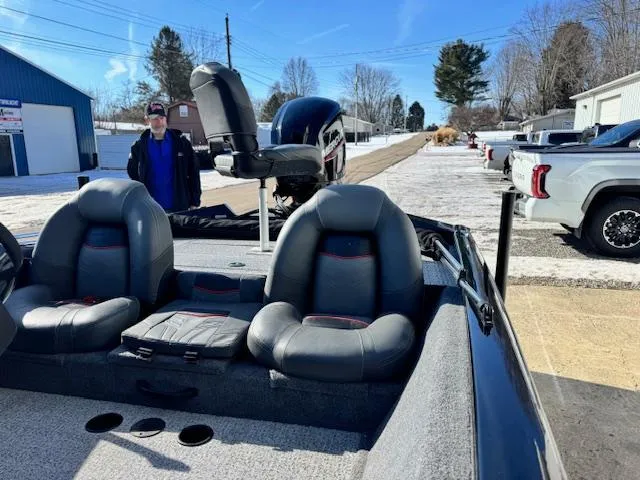 Slide: The Image of 2024 Bass Tracker Pro Team 175 boat with seating, parked outdoors in a snowy setting. - 9