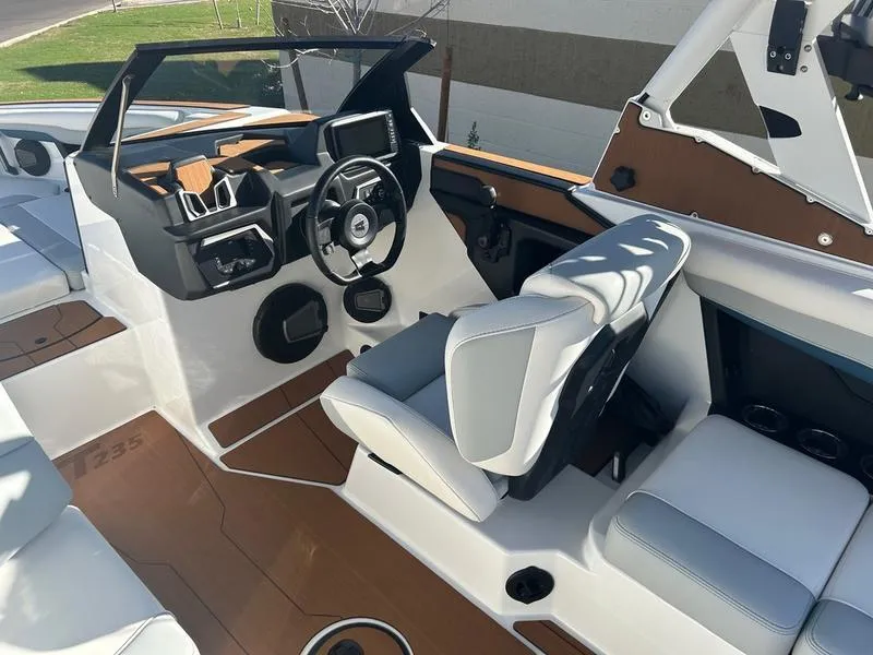 Slide: The Image of 2025 Axis T235 boat interior with modern dashboard and comfortable seating. - 12