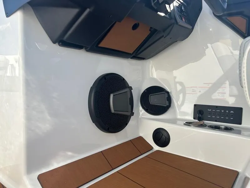 Slide: The Image of Interior of 2025 Axis T235 boat featuring speakers and control panel. - 14