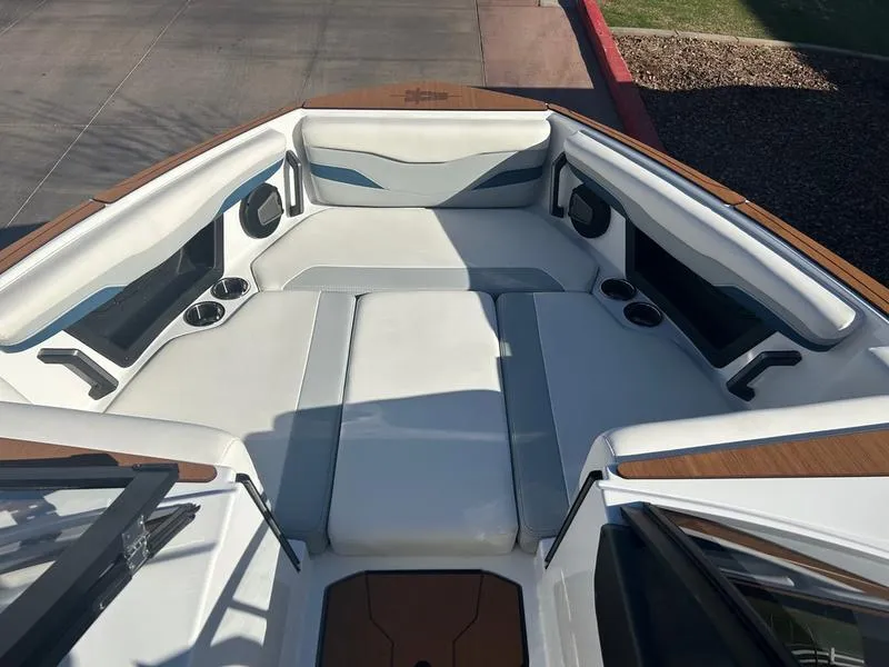 Slide: The Image of 2025 Axis T235 boat interior with white seating and cup holders. - 16