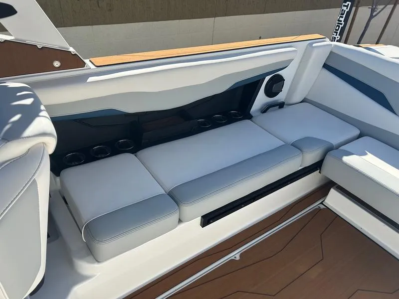 Slide: The Image of Interior seating of 2025 Axis T235 boat with cushioned seats and cup holders. - 18