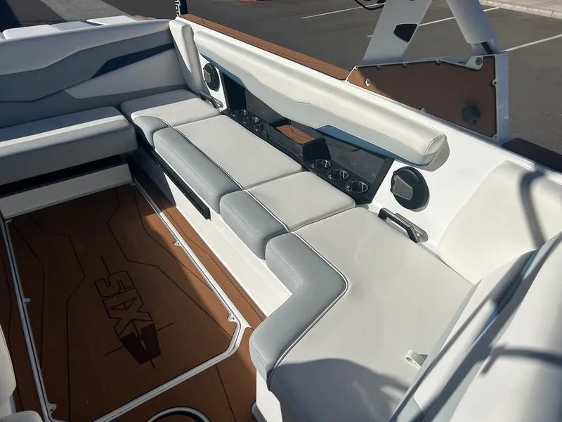 Slide: The Image of Axis T235 2025 boat interior with gray seating and wood accents. - 19